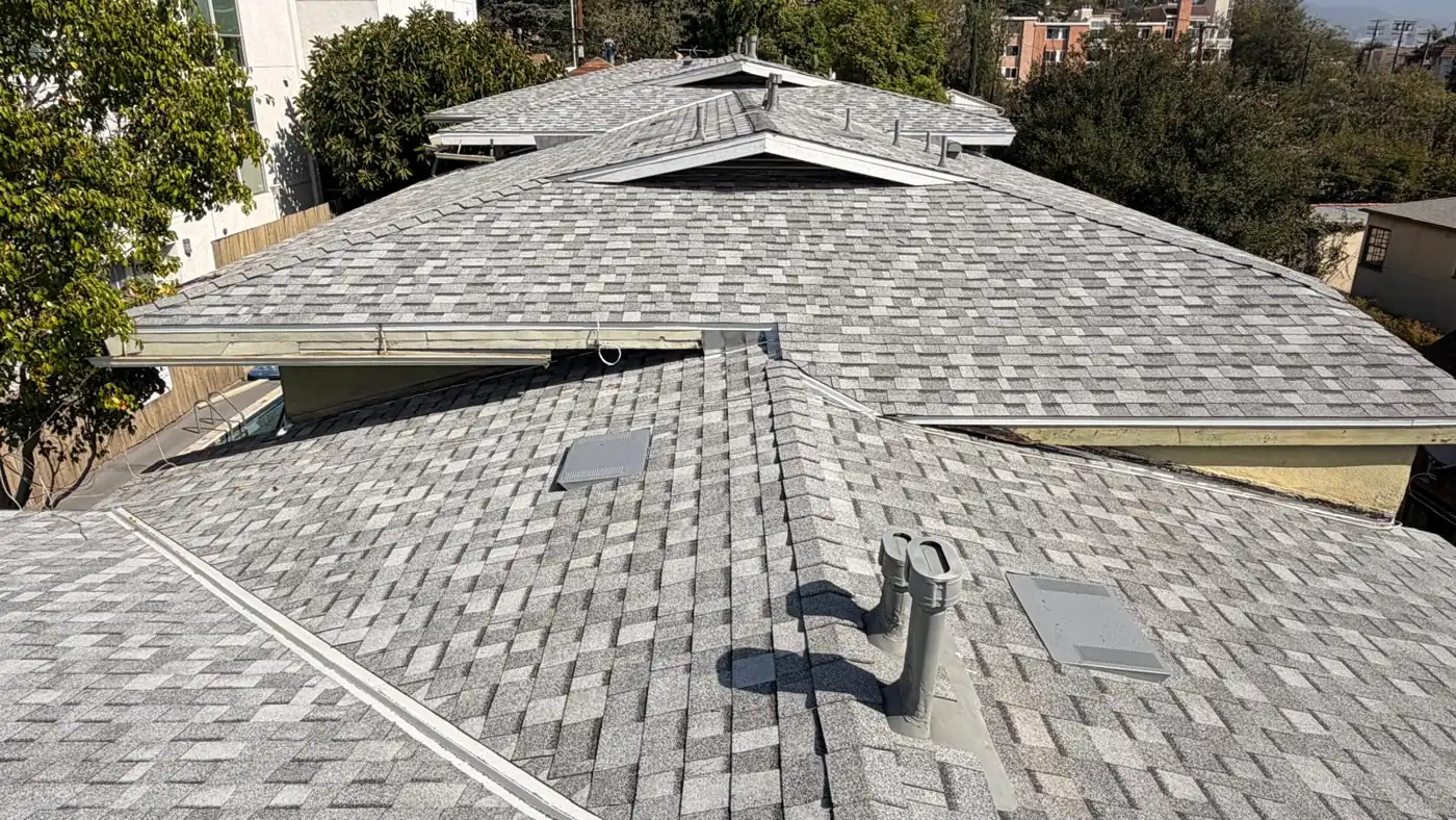 New gray shingles with pipe vents, a skylight and several gable ends on a Los Angeles apartment building