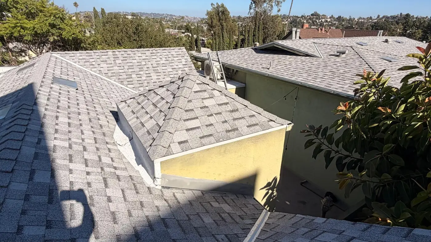 Hip roof sections finished in gray cool roof shingles on a Los Angeles apartment building