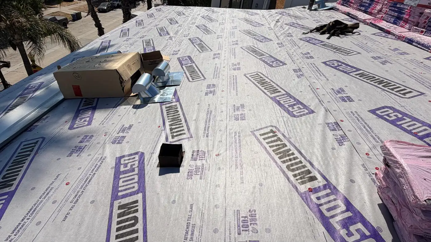New pipe flashings laid out on Titanium underlayment on a Los Angeles apartment building roof