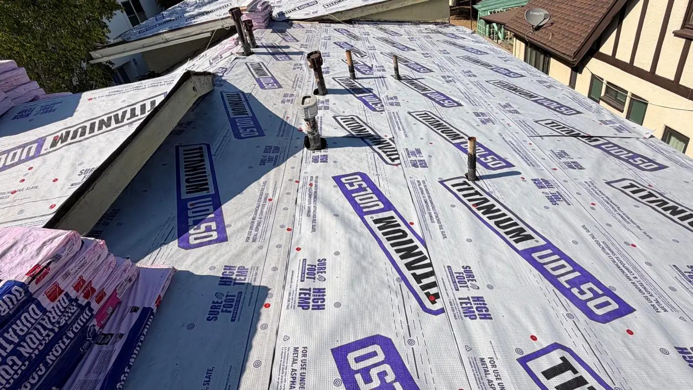 Pipe vents through new underlayment, with Owens Corning Duration COOL shingle bundles staged on a Los Angeles apartment roof