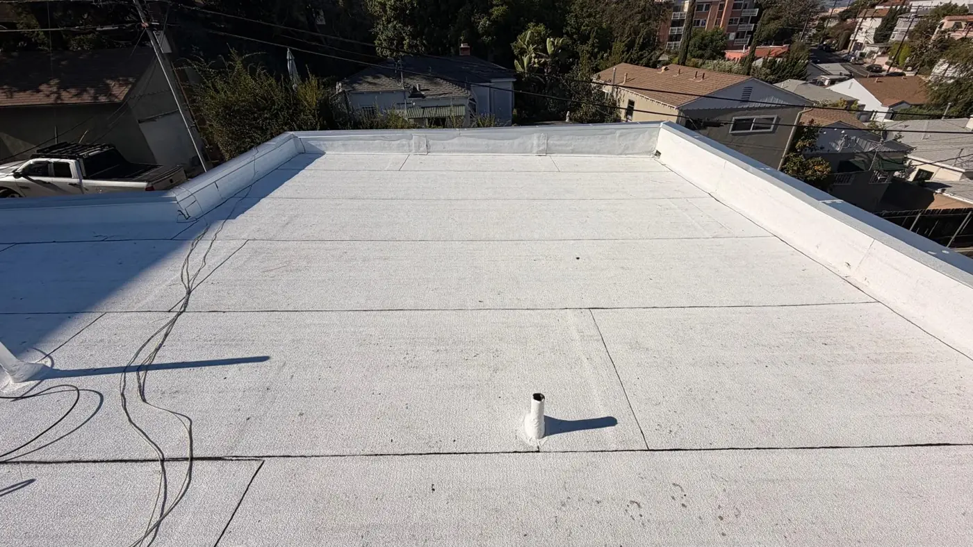 White Polyglass cap sheet finished on the flat roof section of a Los Angeles apartment building