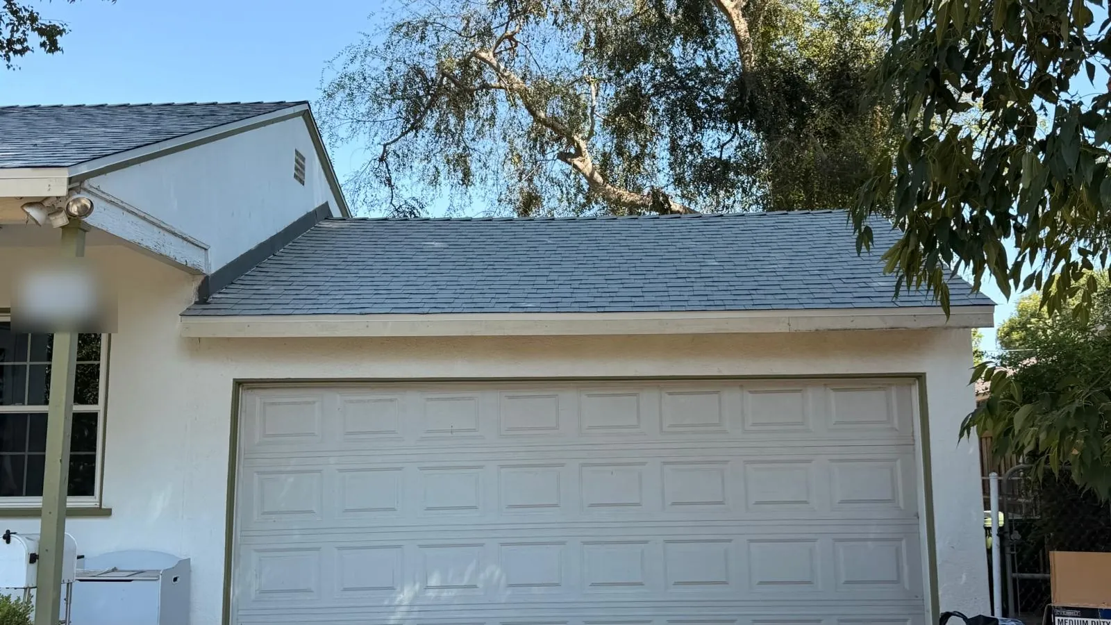 Garage roof covered in new Shasta White composition shingles in Northridge