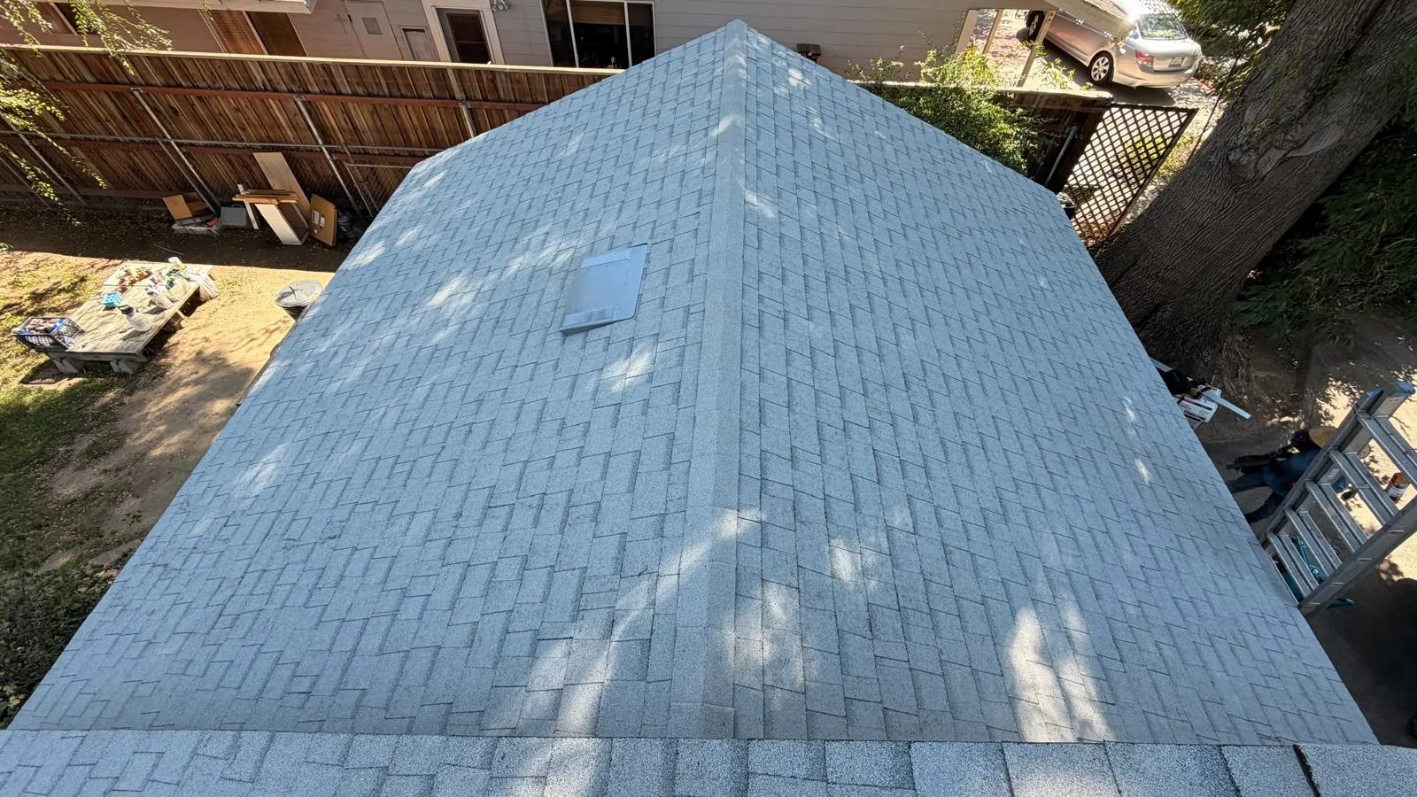 Hip roof section covered in new white Owens Corning shingles in Northridge