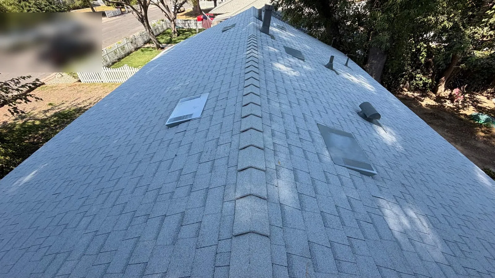 Ridge line of a finished Shasta White cool roof above a Northridge street