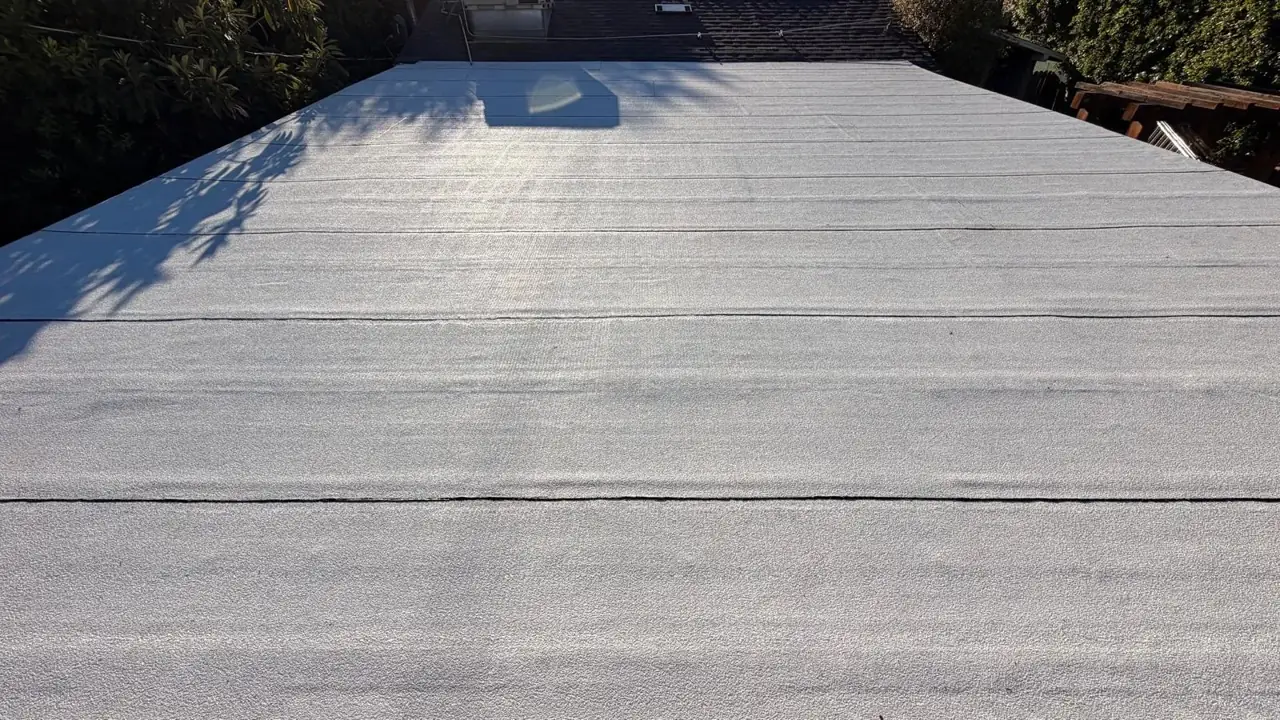 Close view of the white granulated torch-down cap sheet on an Encino flat roof