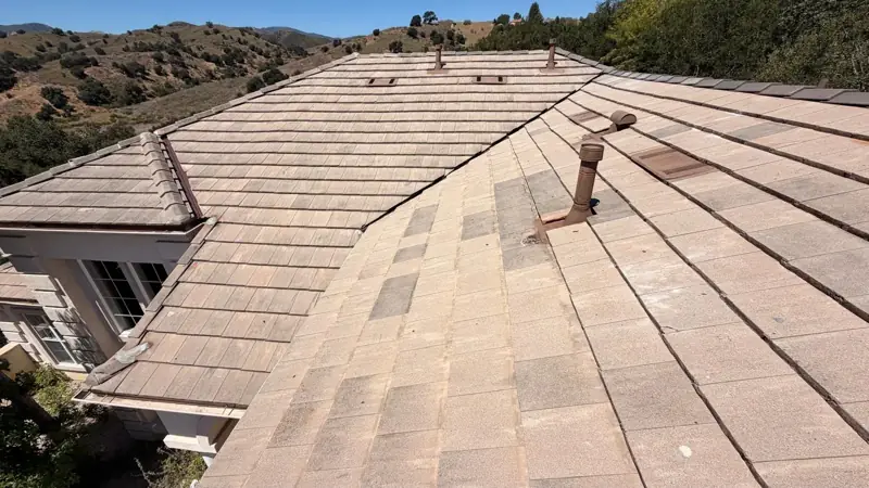 Finished concrete flat tile roof on a two-story Agoura Hills home after the re-felt, with the hills behind it