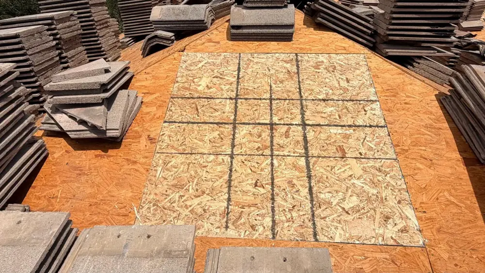 Replacement plywood sheets set into the roof deck where damaged wood was removed